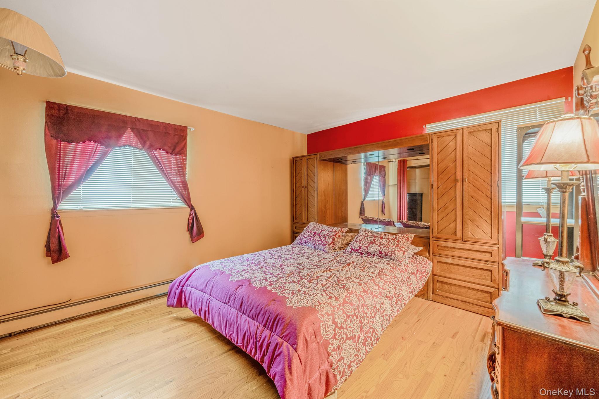 244 Lakeside Trail Ridge, NY 11961 - Photo 32 of 36 Bedroom with wood finished floors and baseboard heating
