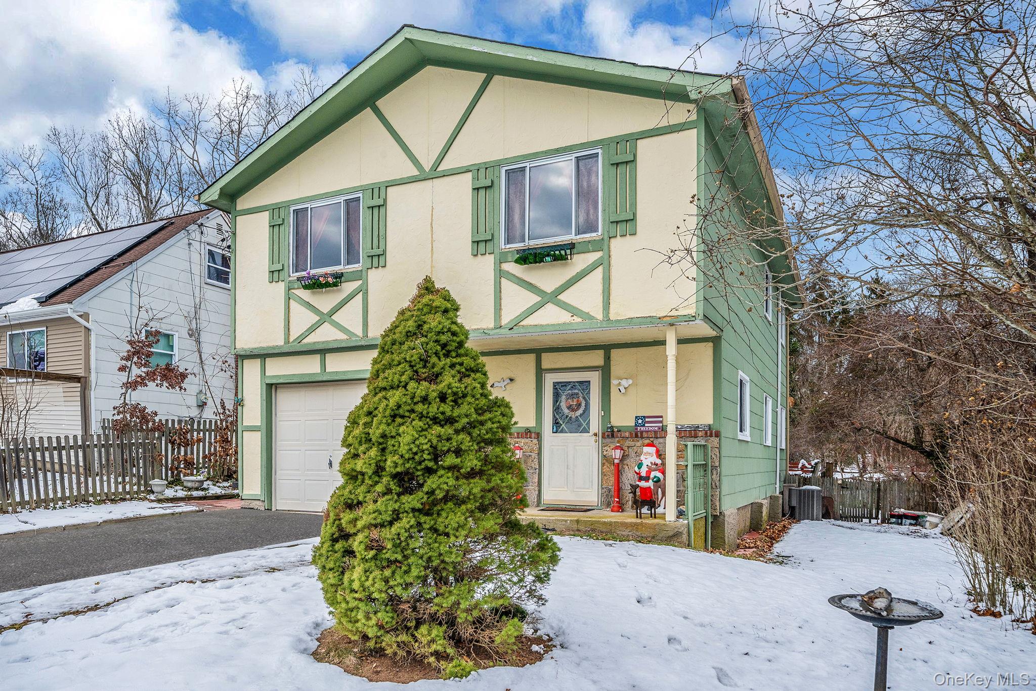 244 Lakeside Trail Ridge, NY 11961 - Photo 6 of 36 View of front of house featuring stucco siding, an attached garage, and asphalt driveway