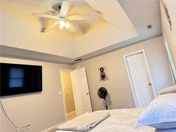 a bedroom with a bed and a flat screen tv