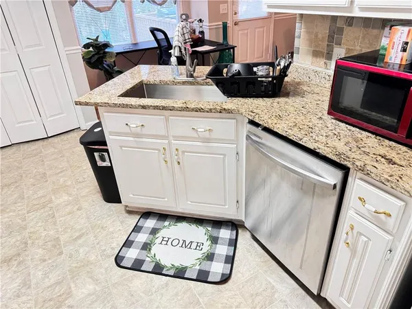 a kitchen with sink and refrigerator