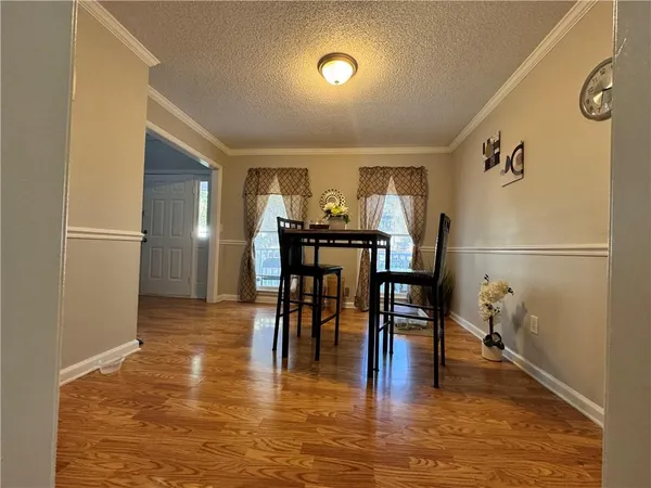 a view of a dining room with furniture and wooden floor