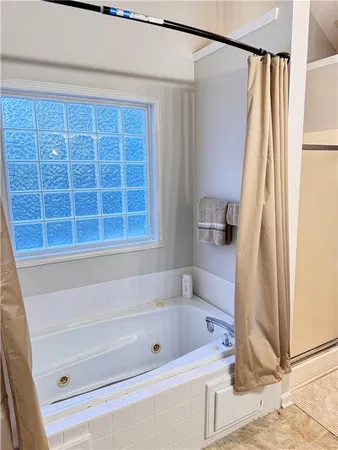 a bathroom with a tub and a shower