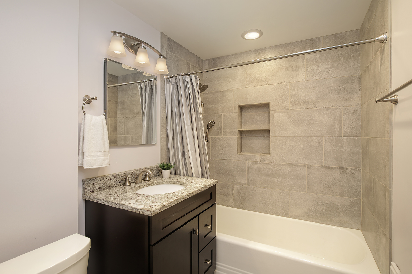 2607 Ridge Avenue Evanston, IL 60201 - Photo 13 of 22 a bathroom with a granite countertop sink shower and a mirror