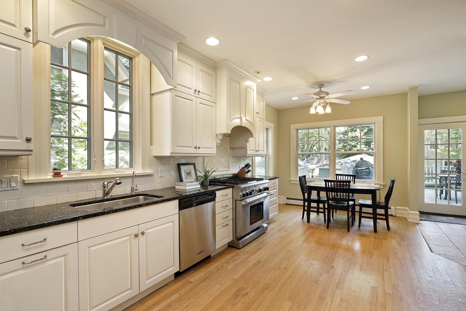 2607 Ridge Avenue Evanston, IL 60201 - Photo 6 of 22 a kitchen with stainless steel appliances granite countertop a stove a sink dishwasher a dining table and chairs with wooden floor