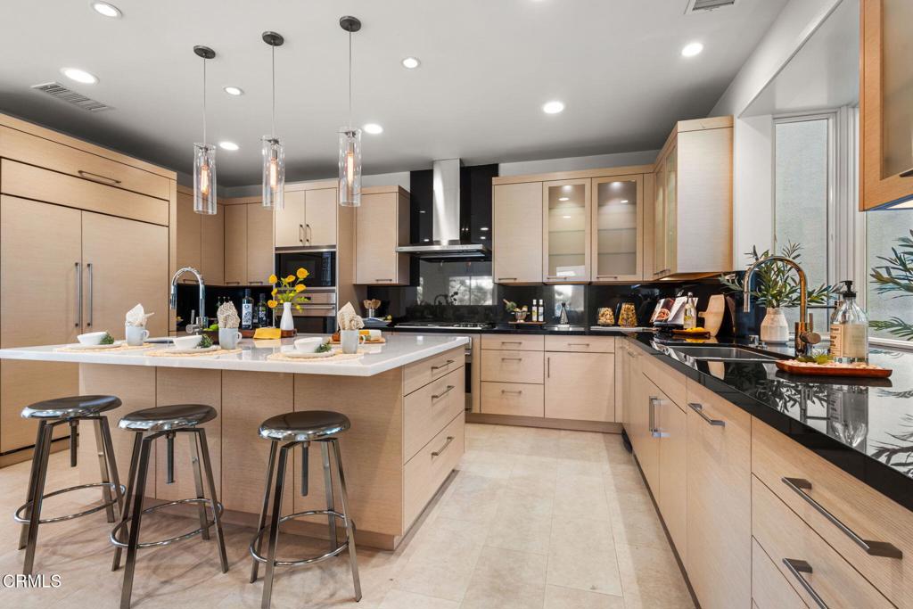 1265 Chateau Road Pasadena, CA 91105 - Photo 14 of 64 a kitchen with stainless steel appliances kitchen island granite countertop a sink and cabinets