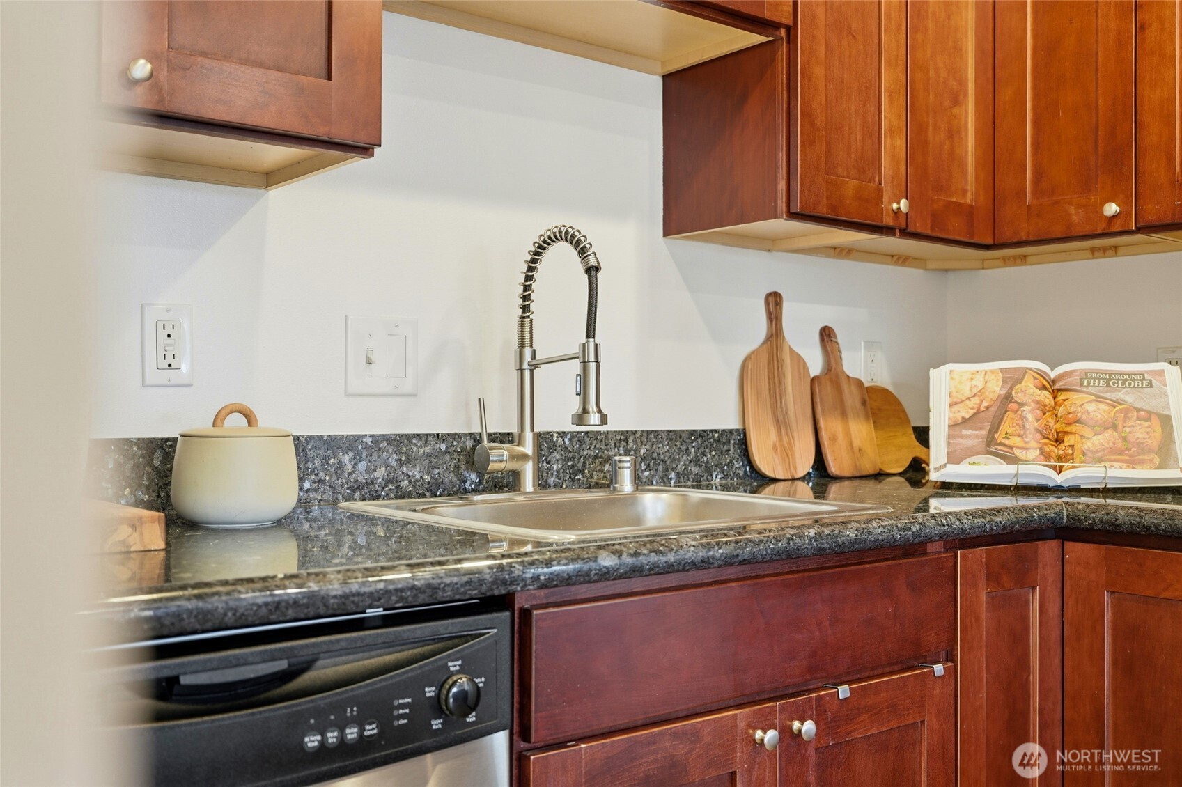 705 East Republican Street, Unit 403 Seattle, WA 98102 - Photo 12 of 28 a kitchen with granite countertop stainless steel appliances a sink and cabinets