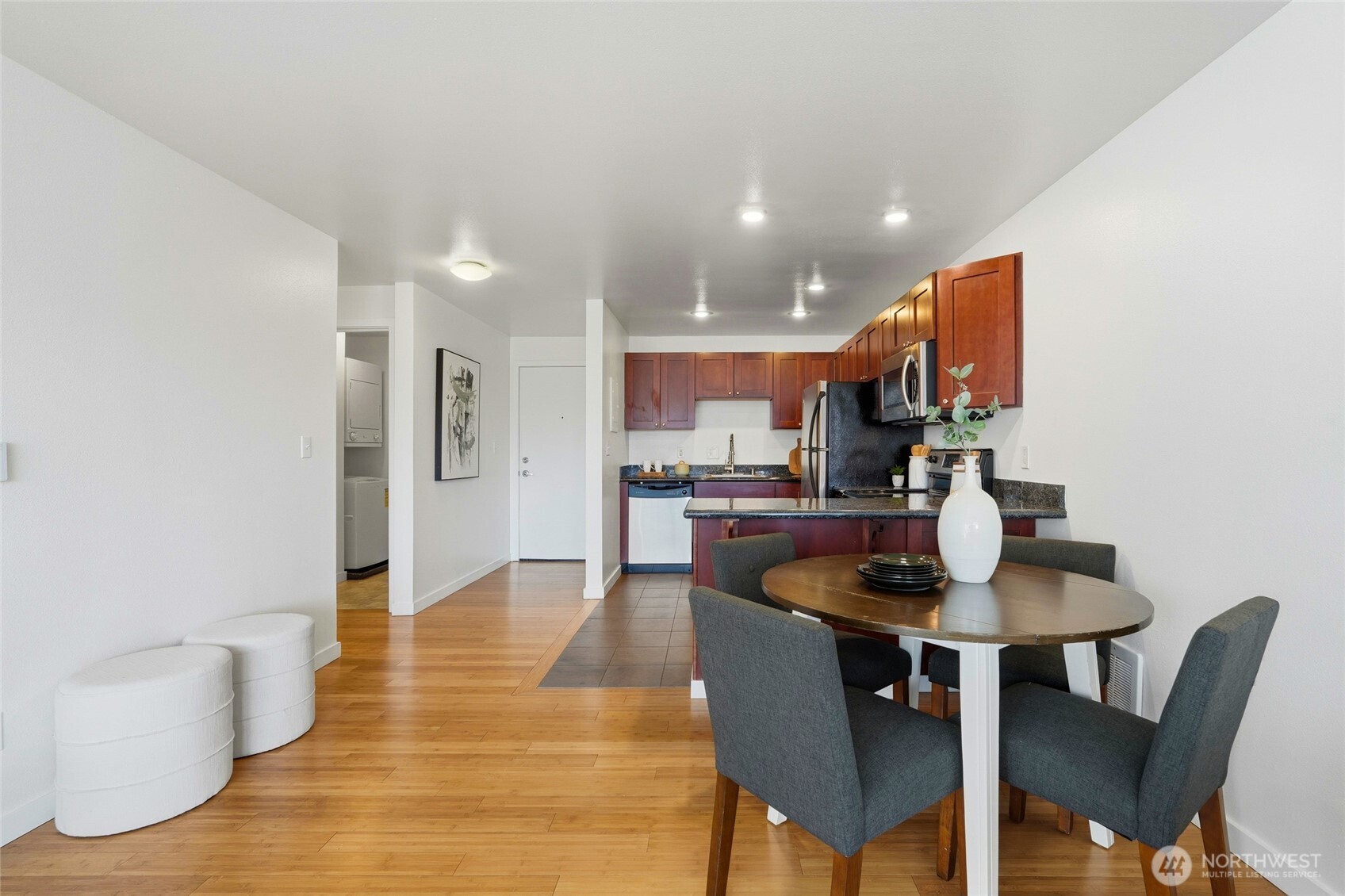 705 East Republican Street, Unit 403 Seattle, WA 98102 - Photo 13 of 28 a dining room with furniture and wooden floor