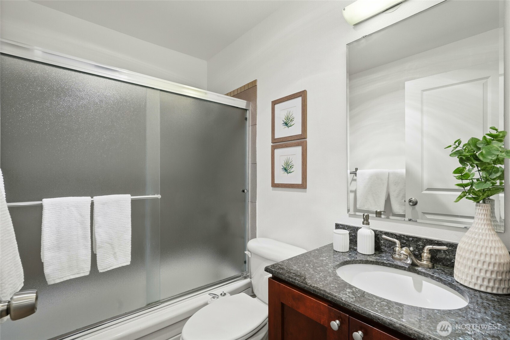 705 East Republican Street, Unit 403 Seattle, WA 98102 - Photo 20 of 28 a bathroom with a granite countertop sink toilet and shower