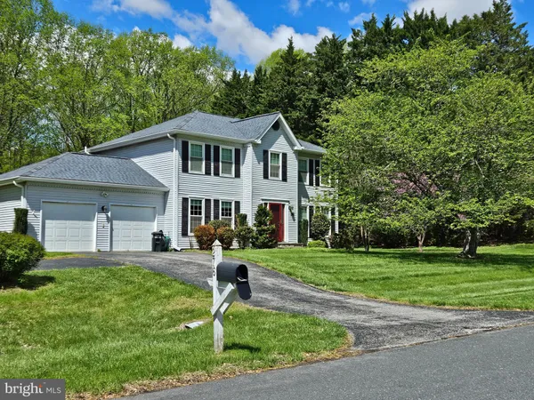 a front view of a house with a yard table and chairs
