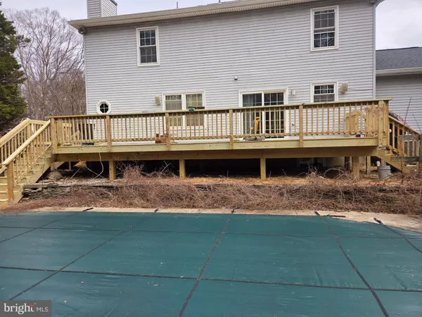 a view of a house with pool and deck