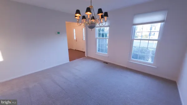 a view of livingroom with chandelier fan and window