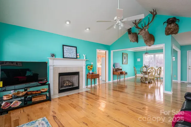 a living room with furniture fireplace and flat screen tv