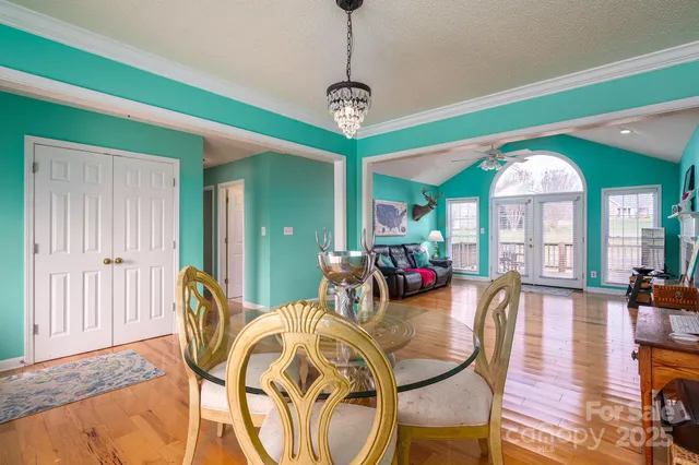 a view of a dining room with furniture wooden floor and chandelier