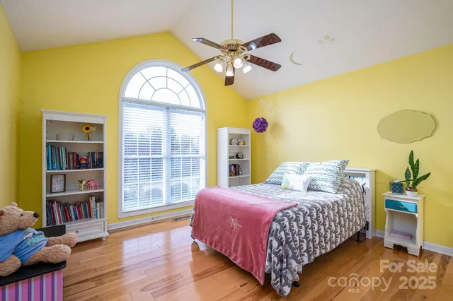 a bedroom with a bed and a large window