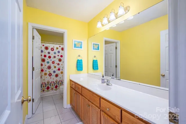 a bathroom with a double vanity sink and a mirror