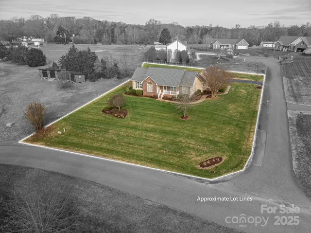 an aerial view of a house with a yard