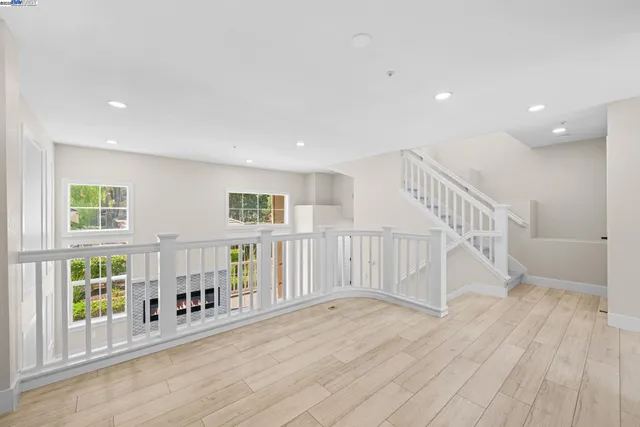a view of front door with wooden floor and windows