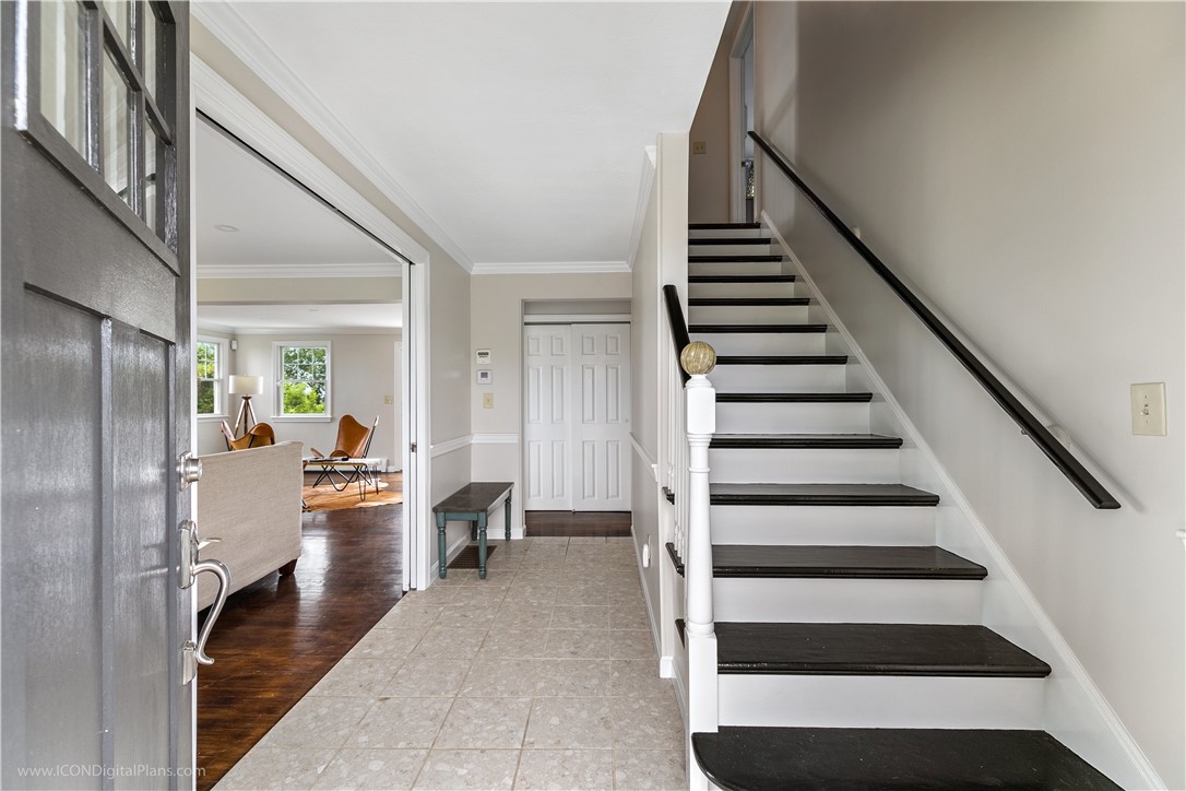 85 Lepes Road Portsmouth, RI 02871 - Photo 6 of 50 This formal entry leads into the double living room. The staircase to the right leads to the second floor bedrooms and 2 full baths.