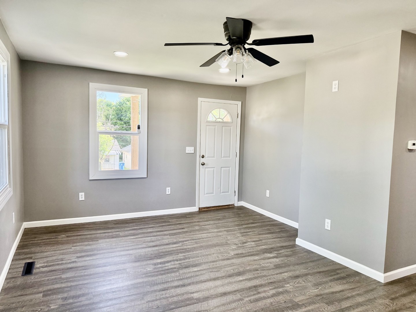 2703 Main Street Peru, IL 61354 - Photo 8 of 23 a view of an empty room with wooden floor and a window