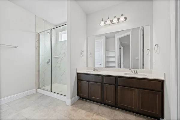 a bathroom with a double vanity sink and a mirror