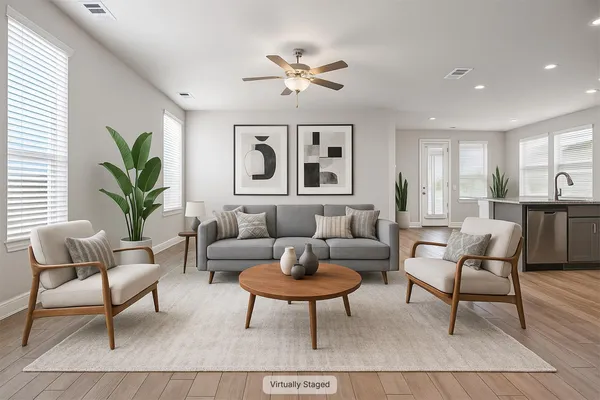 a living room with furniture potted plant and window