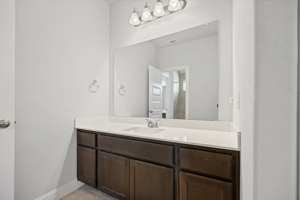 a bathroom with a sink a mirror and a vanity