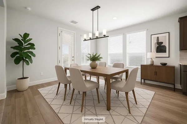 a view of a dining room with furniture window and wooden floor