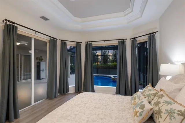 a bedroom with a large window and walk in closet