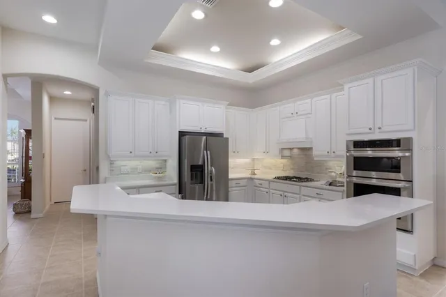 a kitchen with granite countertop white cabinets and white appliances