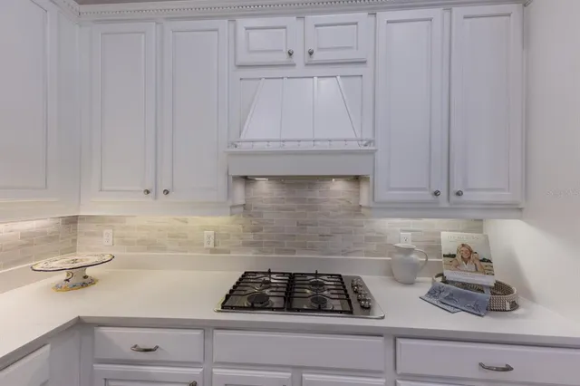a dining room with furniture wooden floor and a chandelier
