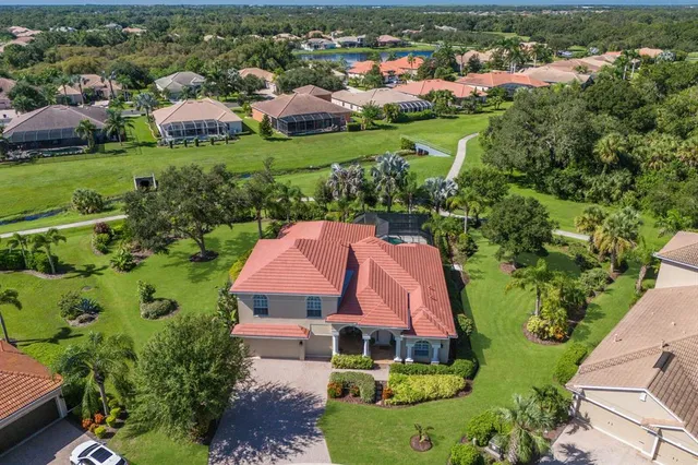 an aerial view of house with yard swimming pool and outdoor seating