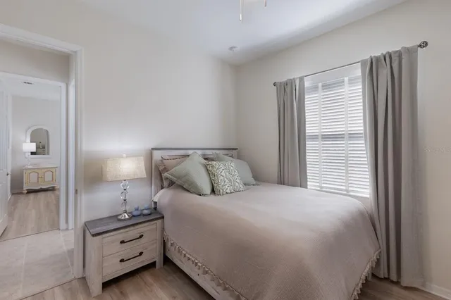 a bedroom with a bed and a painting on the wall