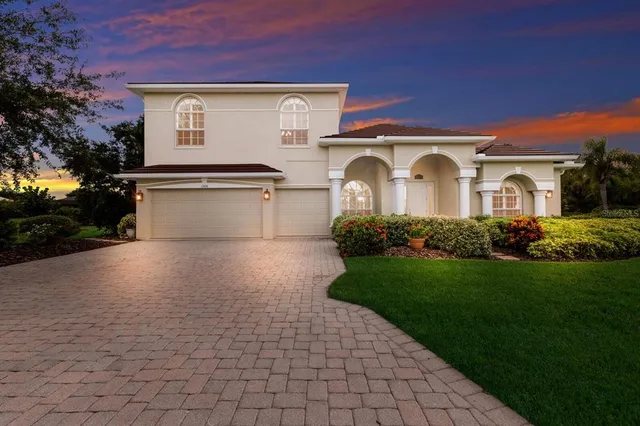 a front view of a house with a yard and garage
