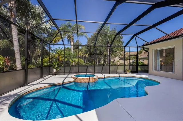 an aerial view of a house with yard swimming pool and outdoor seating