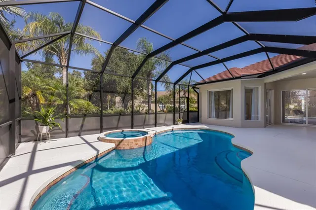 an aerial view of a house yard swimming pool and outdoor seating