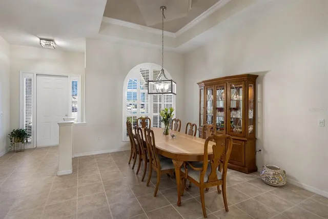 a view of a dining room with furniture and a chandelier