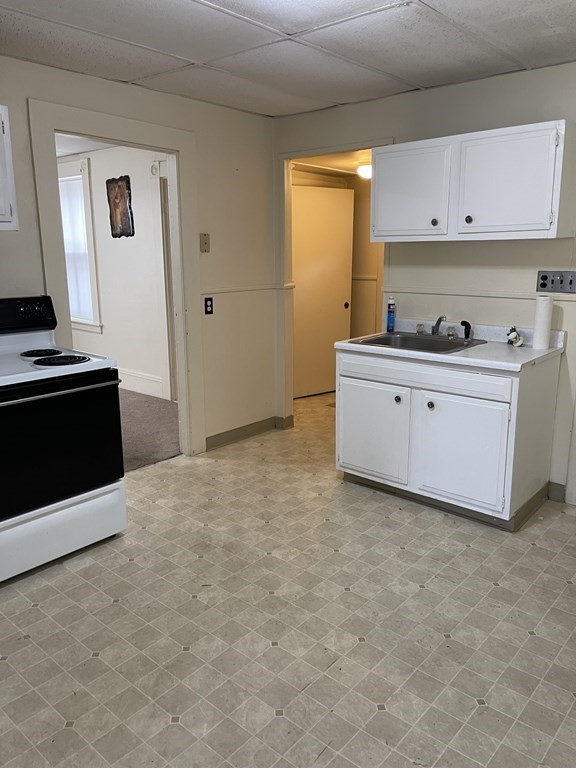 352 Broadway Lynn, MA 01904 - Photo 3 of 6 a kitchen with cabinets stove and window
