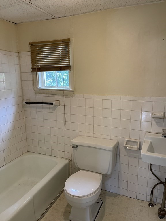 352 Broadway Lynn, MA 01904 - Photo 5 of 6 a bathroom with a toilet a sink and bathtub