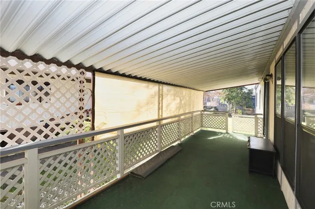 a view of a porch with furniture and garden