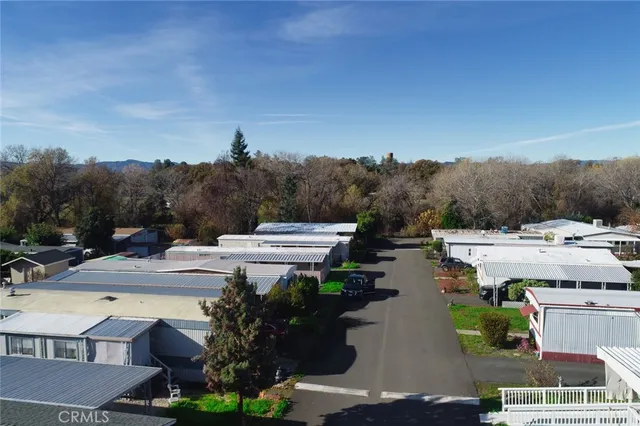 a view of a house with a swimming pool and a yard