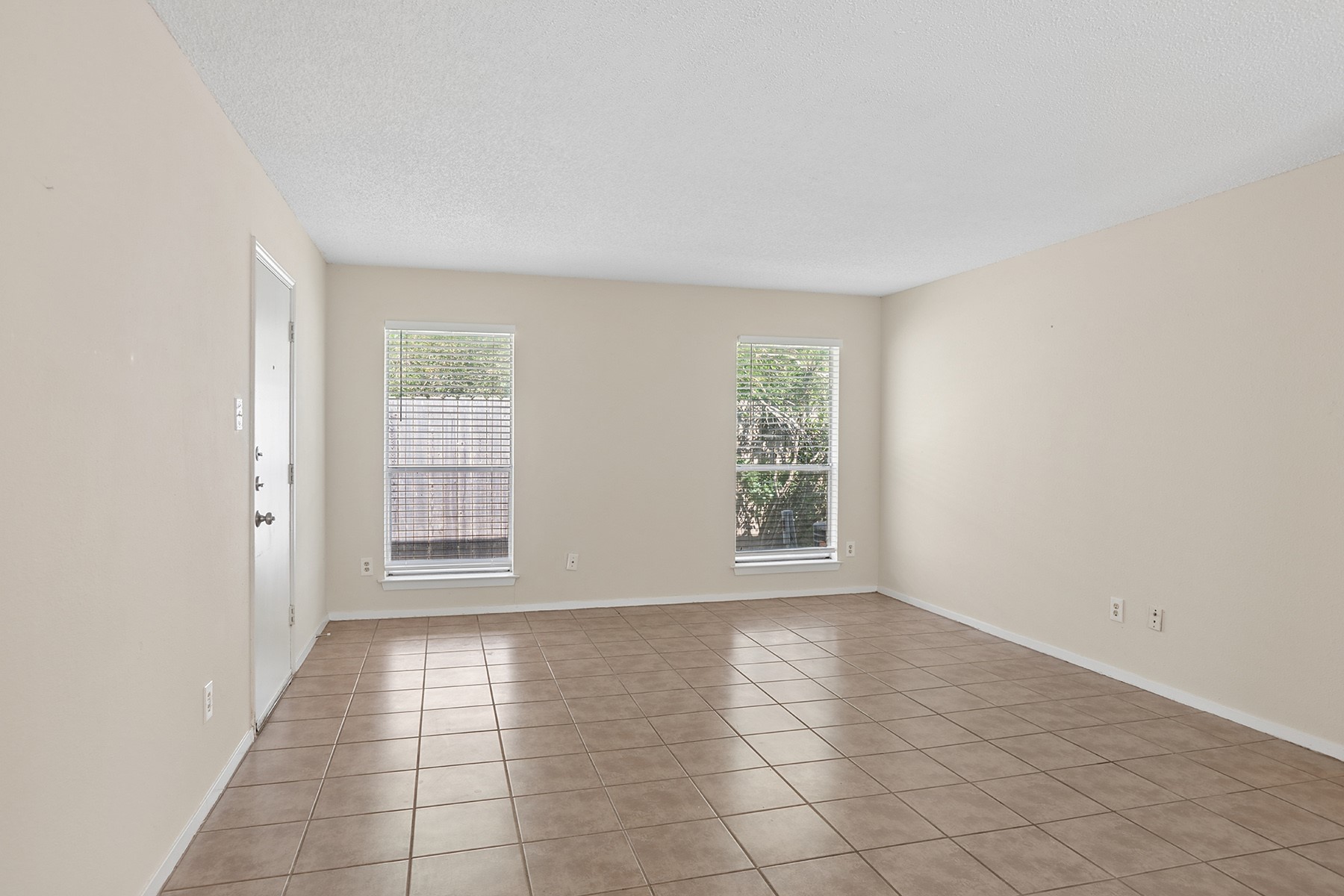 3114 Plantation Road, Unit A Austin, TX 78745 - Photo 3 of 15 The welcoming living room features durable tile flooring and naturally illuminated spaces through two sizable windows.