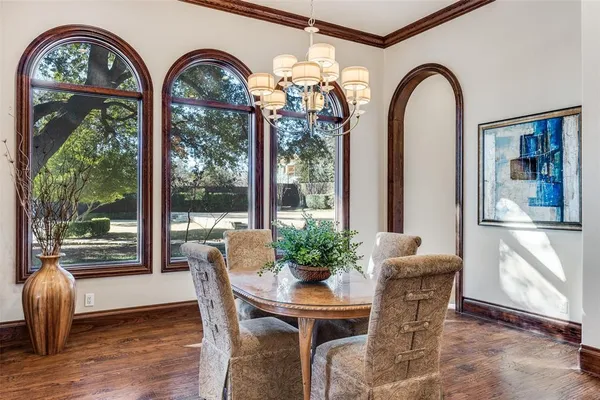 a view of a dining room with furniture and large windows