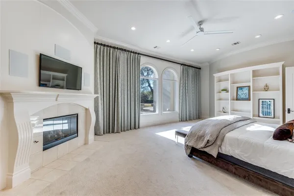 a spacious bedroom with a bed and a flat screen tv