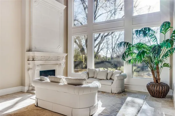 a living room with furniture and a potted plant