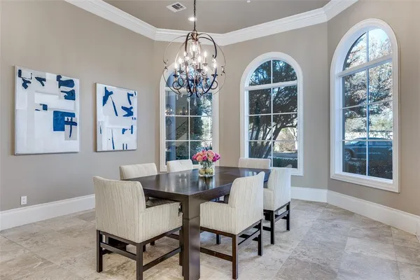 a dining room with furniture a chandelier and window