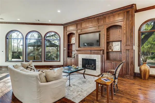 a living room with furniture fireplace and a large window