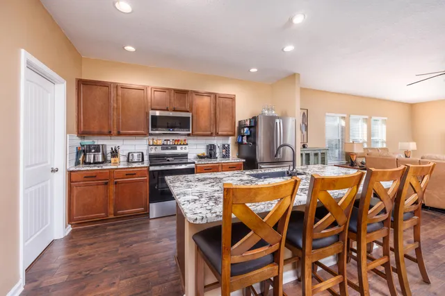 a large kitchen with a table and chairs