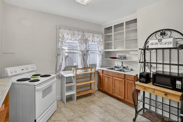 a kitchen with a stove a sink and a refrigerator