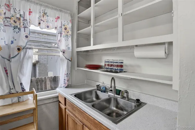 a kitchen with a sink and a refrigerator