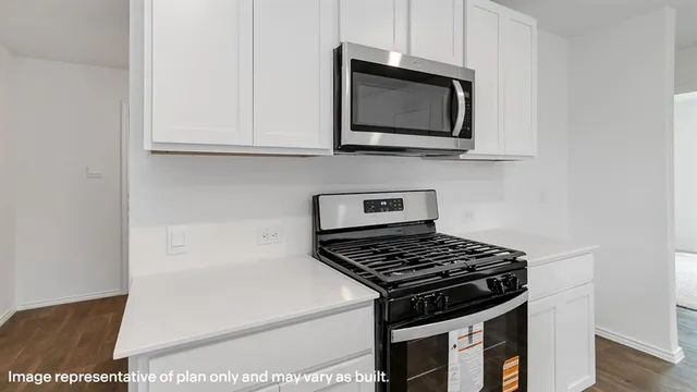 a kitchen with stainless steel appliances granite countertop a stove and a microwave
